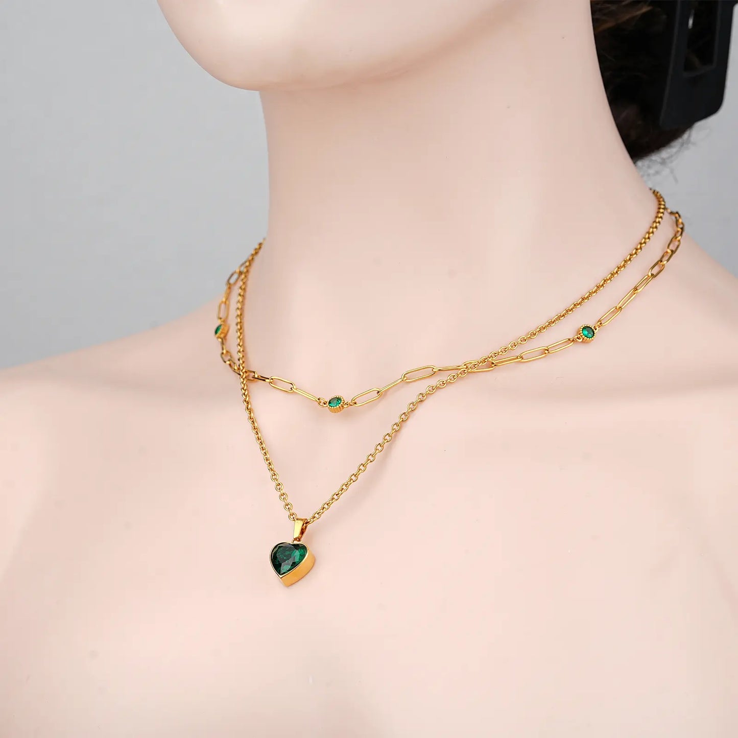 Angled view showing the perfect stacking of the MEHRZEB double layered gold necklace on a model.