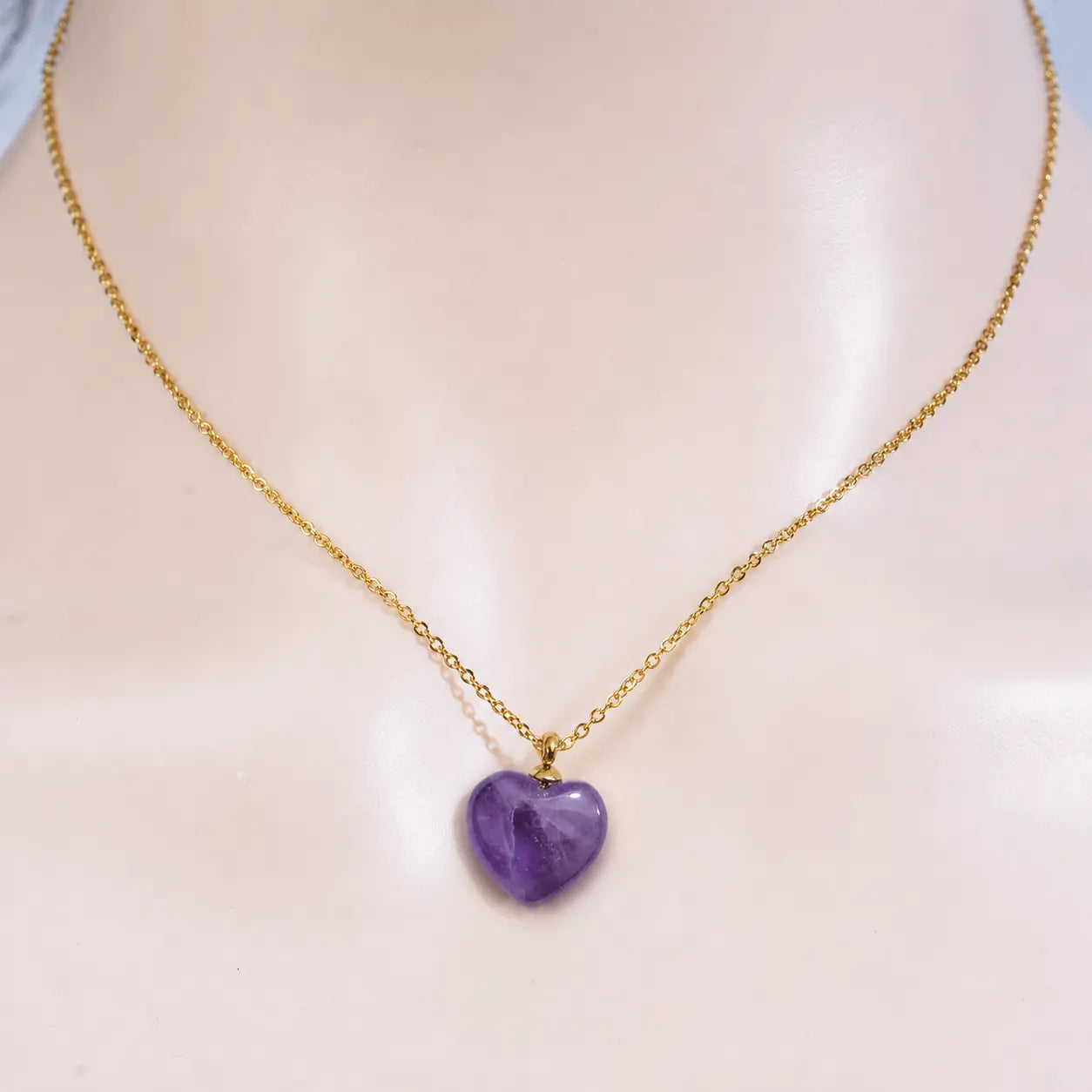 Front view of a model wearing the MEHRZEB luxury purple amethyst heart pendant necklace.