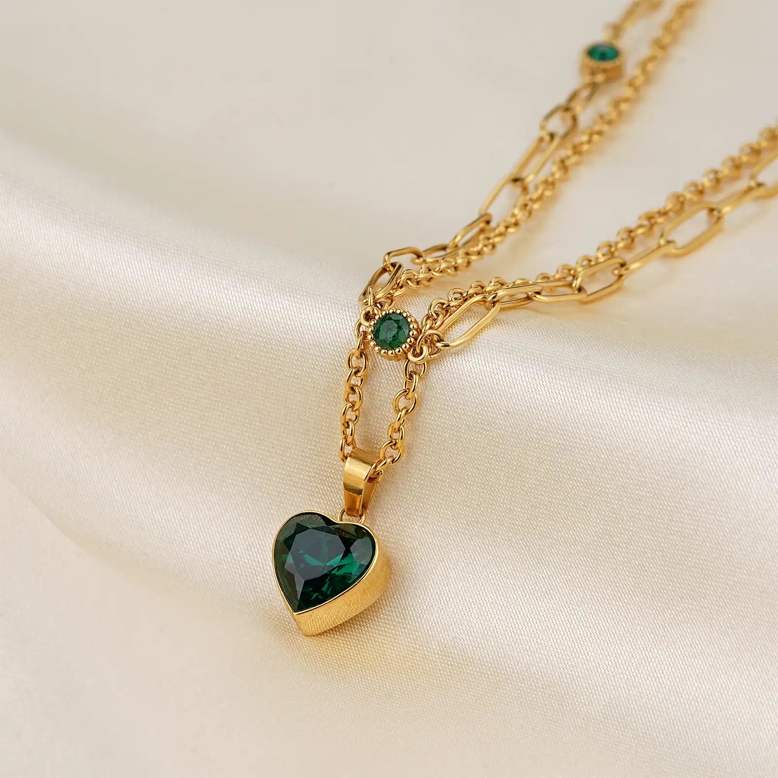 Macro close up of the premium emerald green heart cut zircon stone and 18k gold layered chain by MEHRZEB.