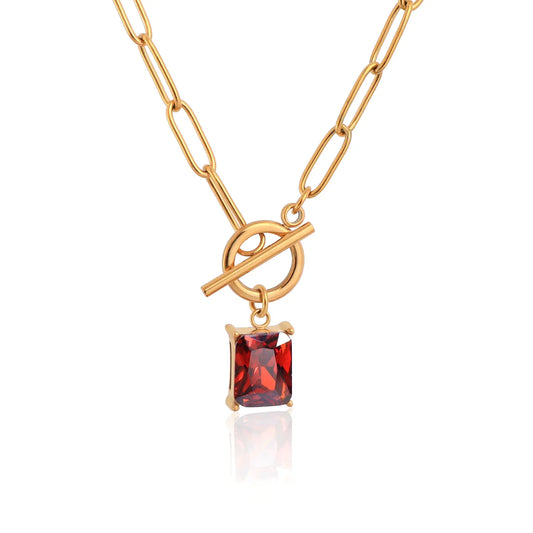 MEHRZEB 18k gold plated paperclip chain necklace with rectangular ruby red zircon on white background.