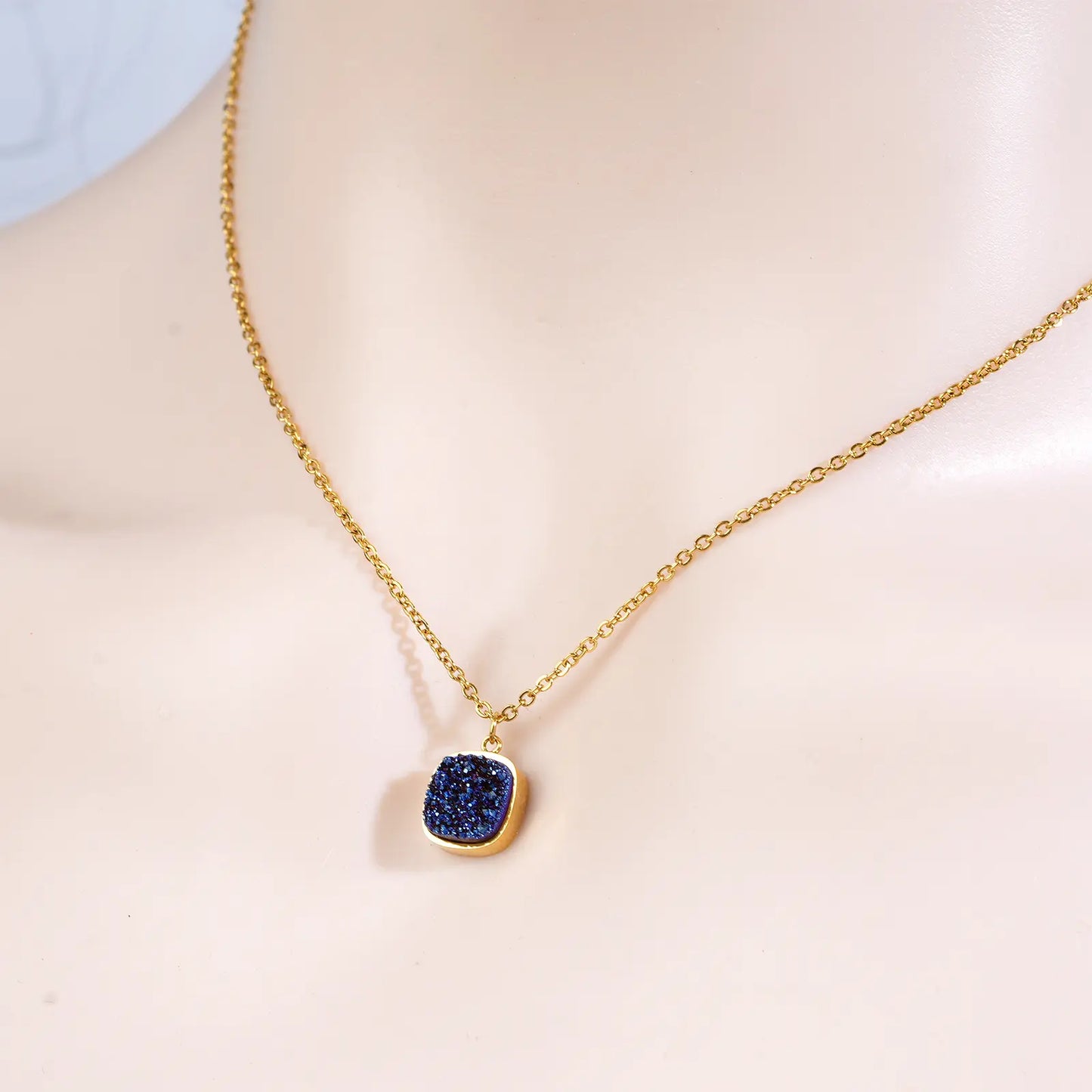 Side angle view of the anti tarnish 18k gold plated blue pendant necklace by MEHRZEB on a model.