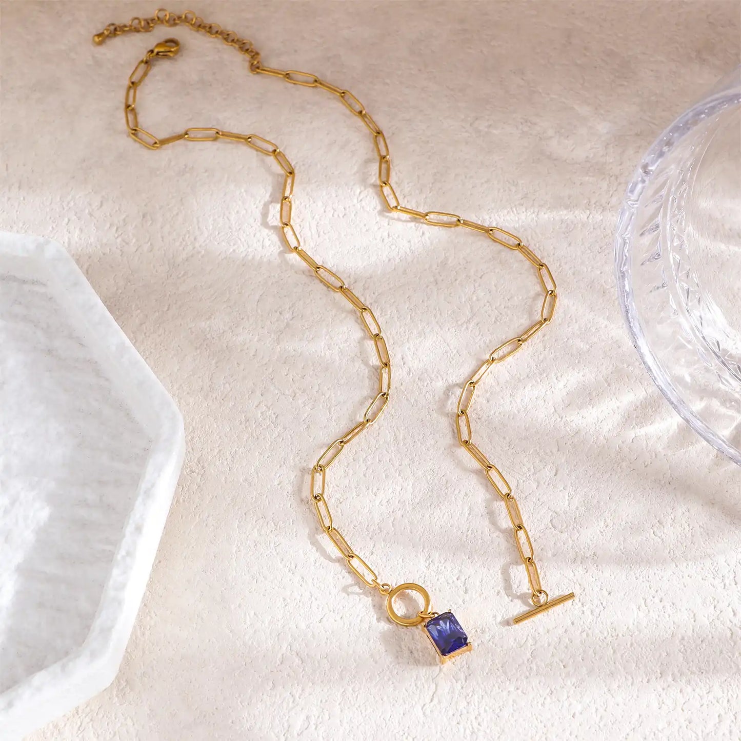 Full length flat lay view of the 18k gold PVD coated paperclip chain by MEHRZEB.