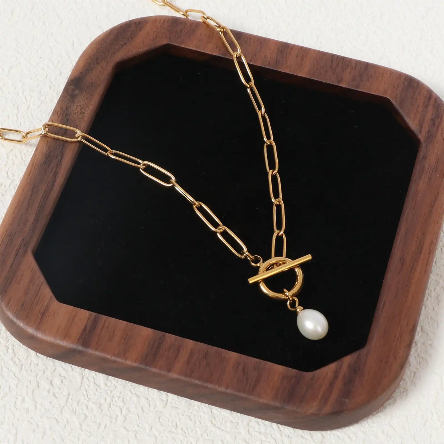MEHRZEB luxury natural pearl necklace elegantly styled on a premium dark walnut wooden jewelry tray.